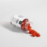 Open jar of red gummy bears with a white label on a light gray background