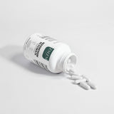 White bottle with a green label on a light gray background