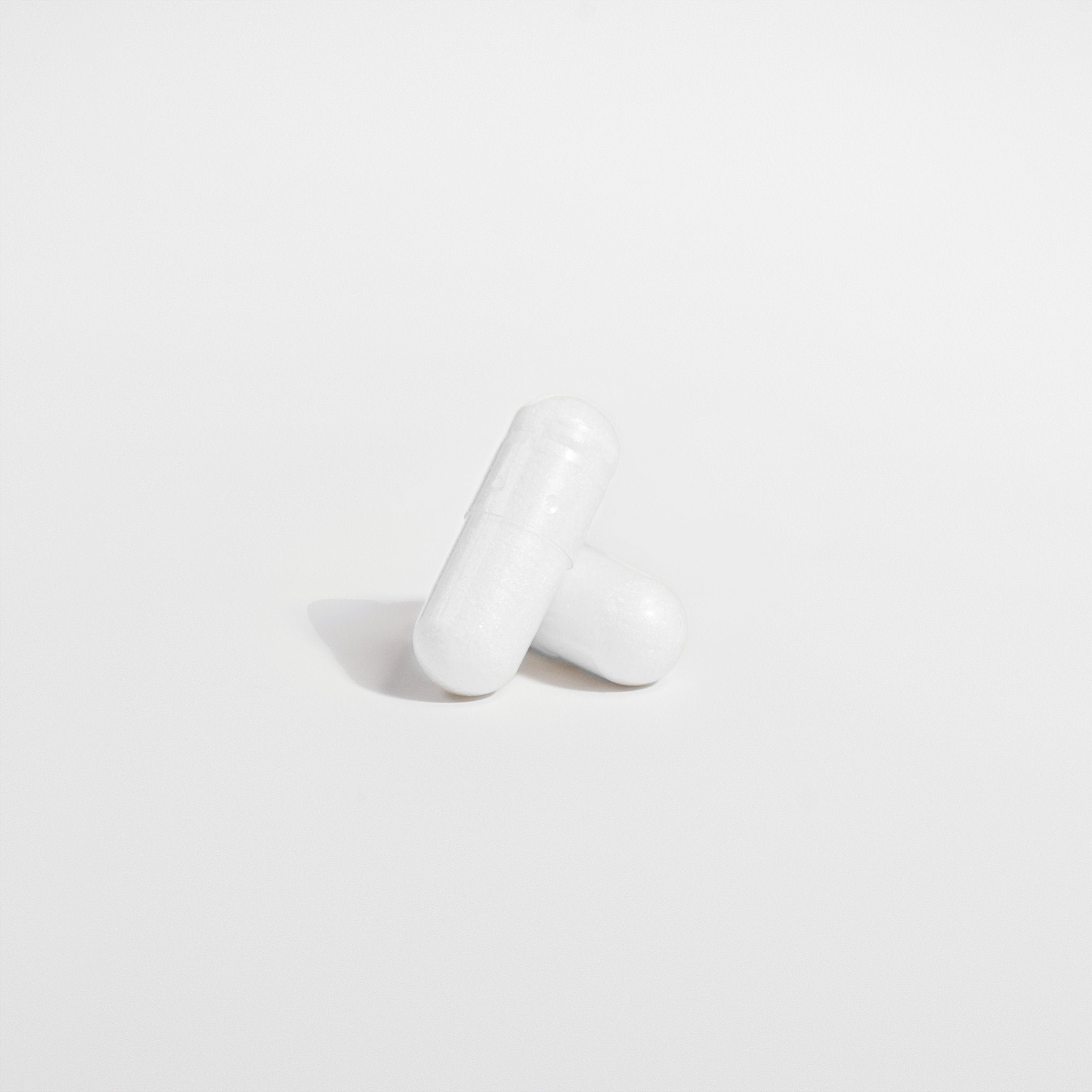 White pill  on a light gray background