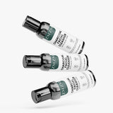 Three bottles of ZMZM Labs Charcoal Facial Cleanser on a white background