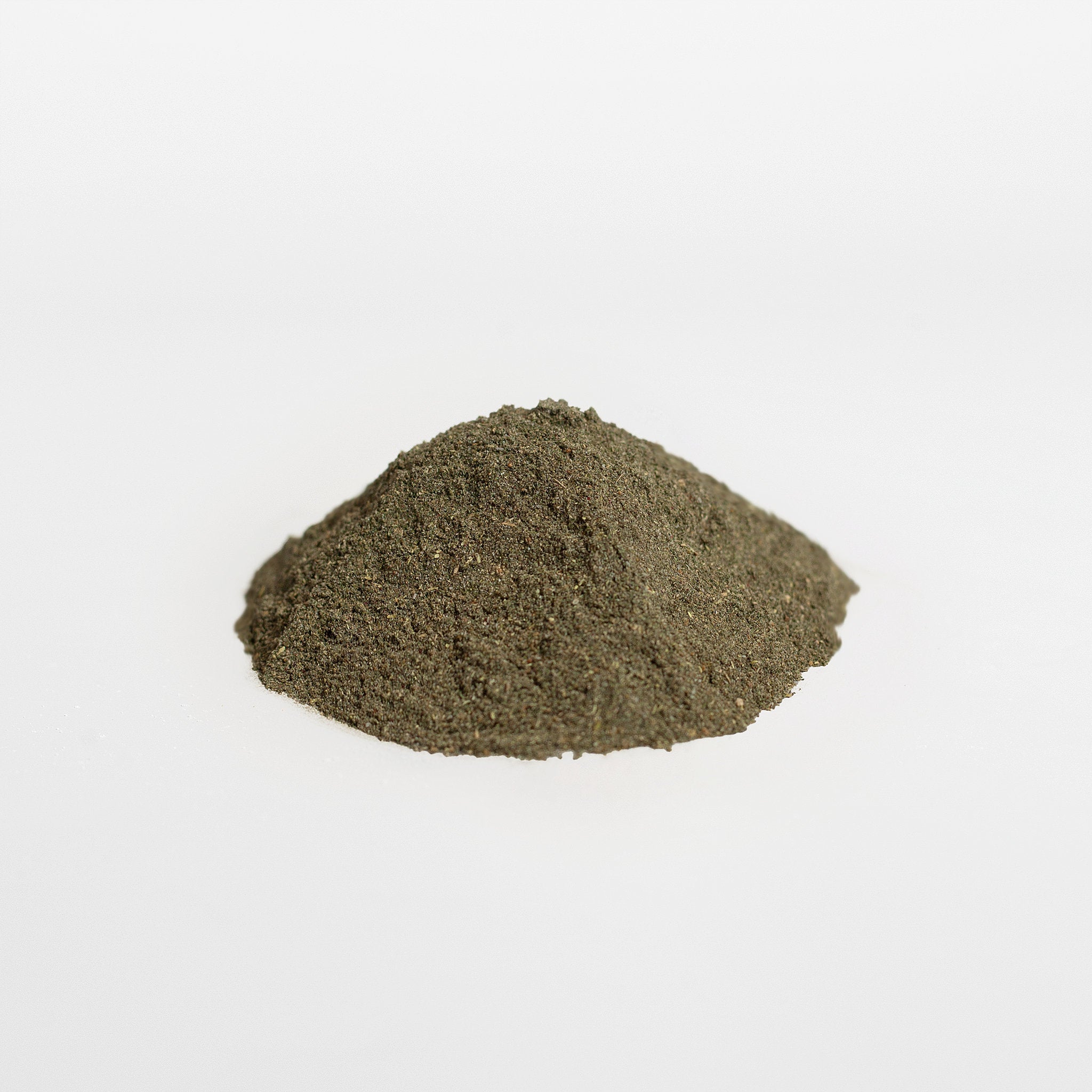 Pile of green powder on a white background