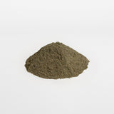 Pile of green powder on a white background