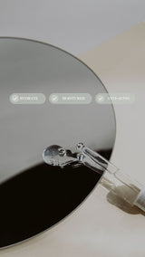 Round metallic object with a handle on a light background